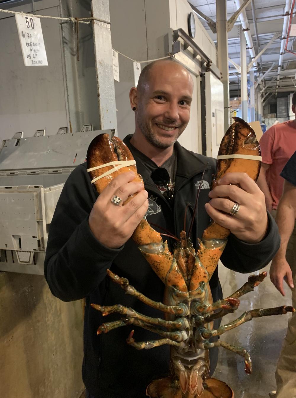 Aaron Staudenmaier of District learning about local seafood during the GCIA Food Tours.