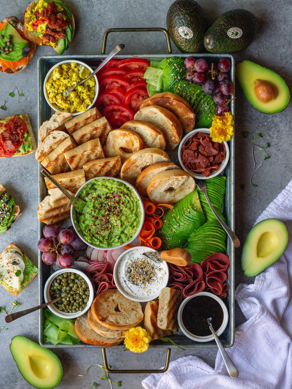 This Springtime Charcuterie Board created by Ashley Hankins featured avocado hummus, vegan avocado ranch dressing and avocado slices accompanied by seasonal fruits, veggies and crackers.