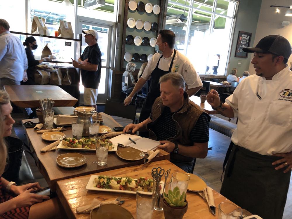 Chef Jason Hernandez (far right) describes California avocado dishes to Urban Plates’ culinary team.