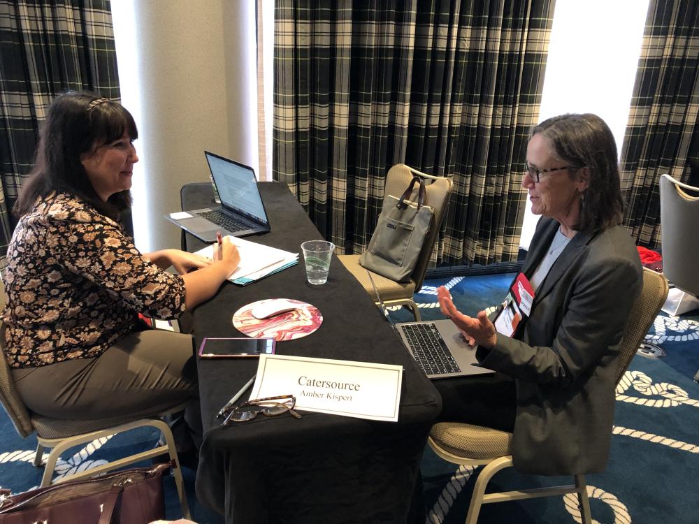 CAC foodservice team member Susan Hughes meeting with Amber Kispert of Catersource during CAC’s “office hours” at IFEC.